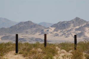 View looking north, with three fenceposts.