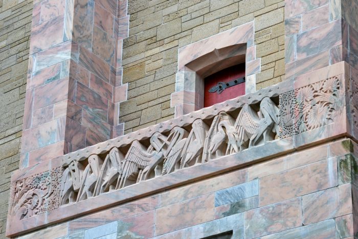 Stone carved pelicans and a red door at Bok Tower, Florida.